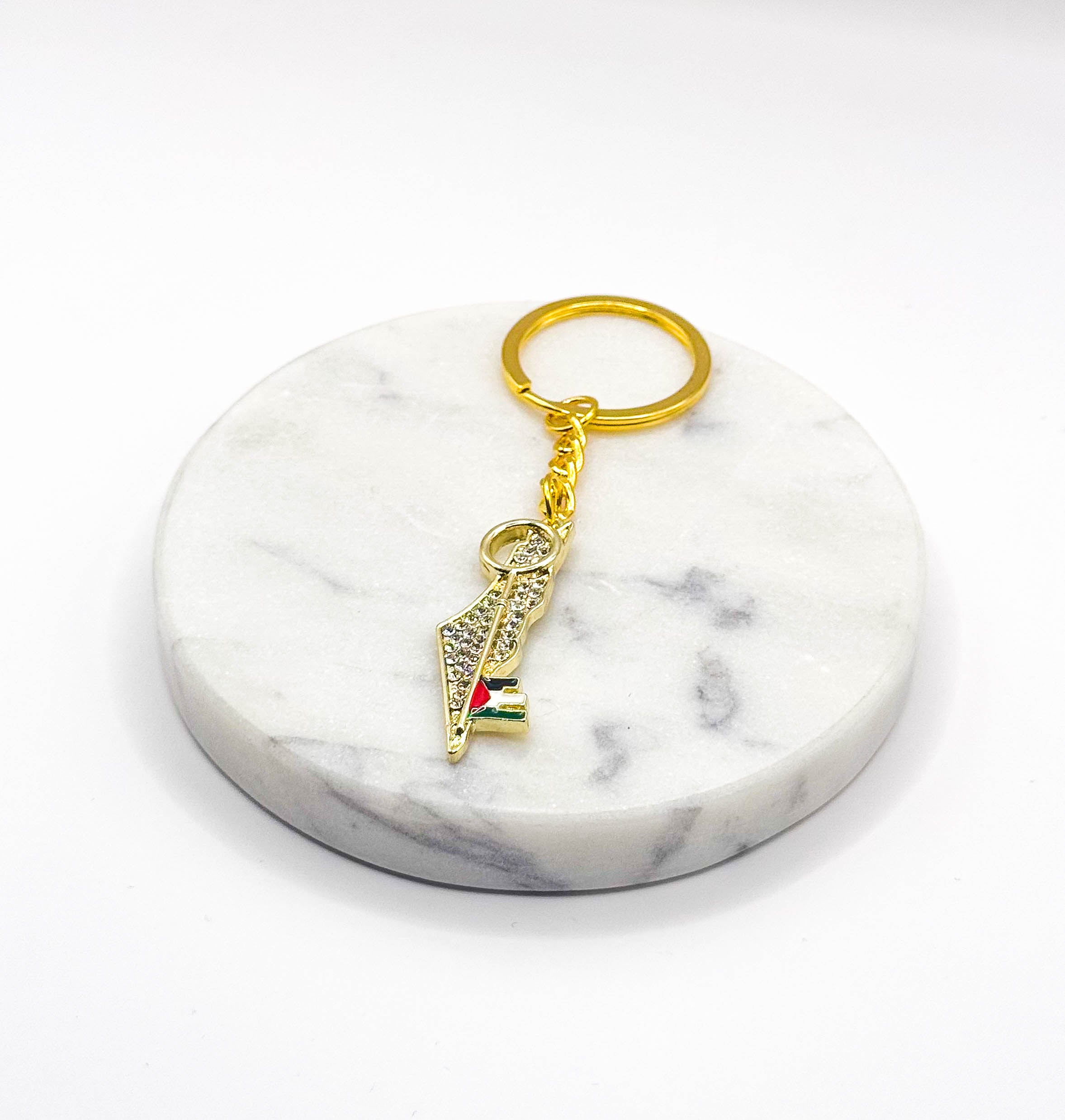 Nøkkelring med anheng formet som Palestina-kart i gullfarget design